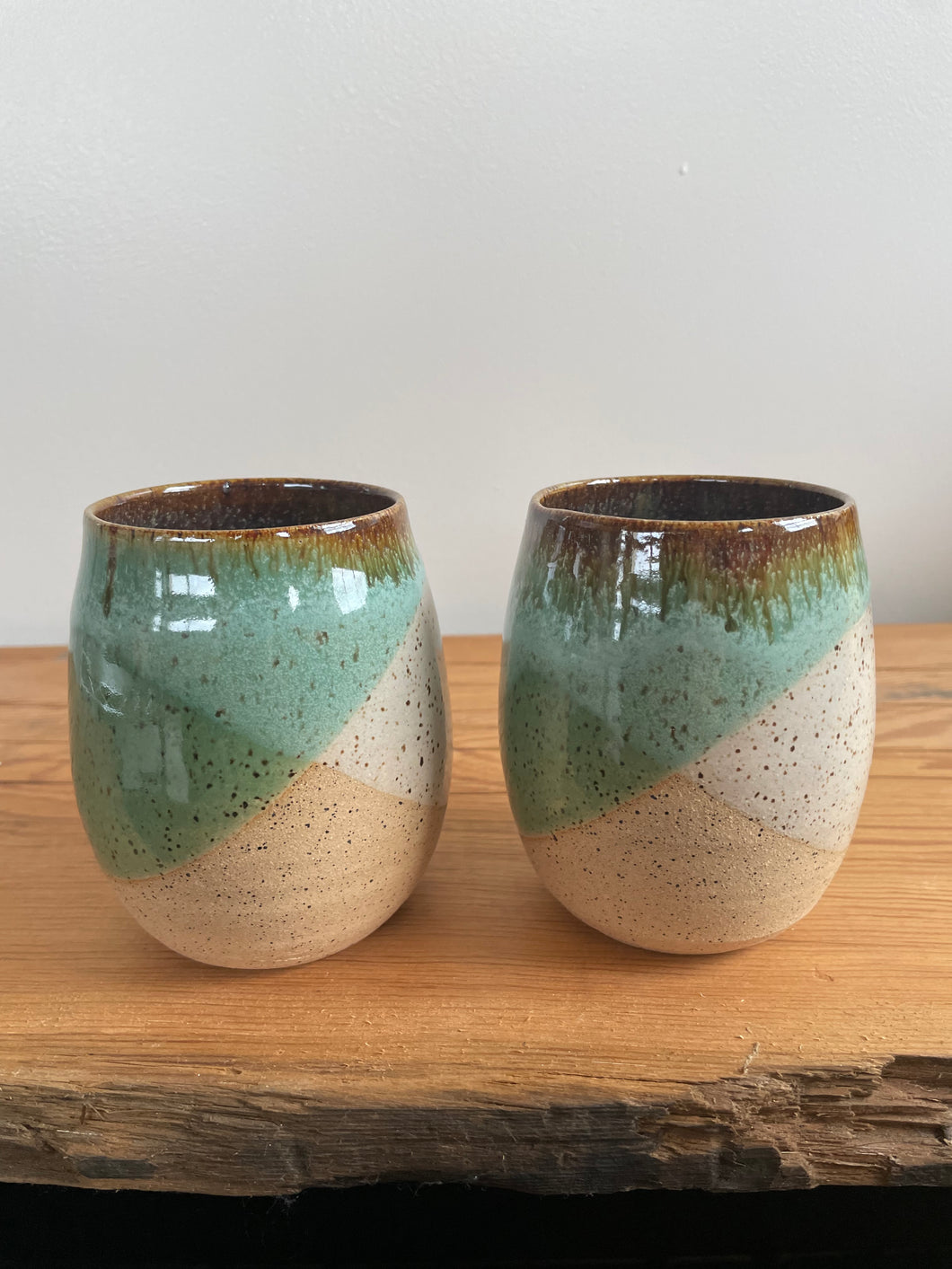 Set of two stoneware wine glasses. Green and white glaze.